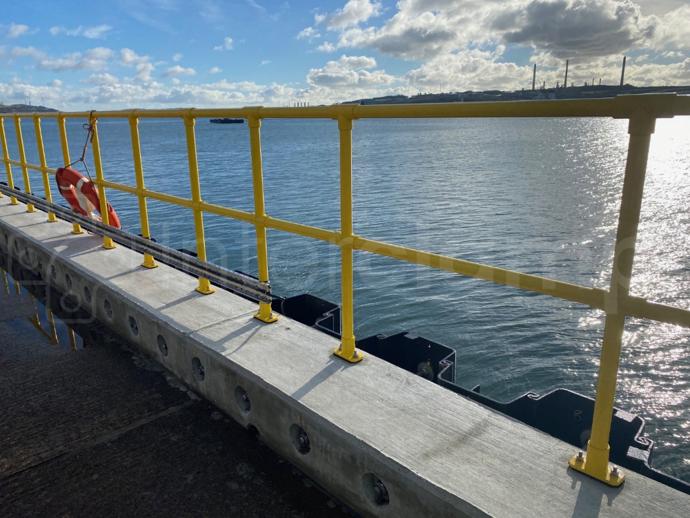 Interclamp fittings and tube powdered coated safety yellow to enhance corrosion resistance installed on a jetty